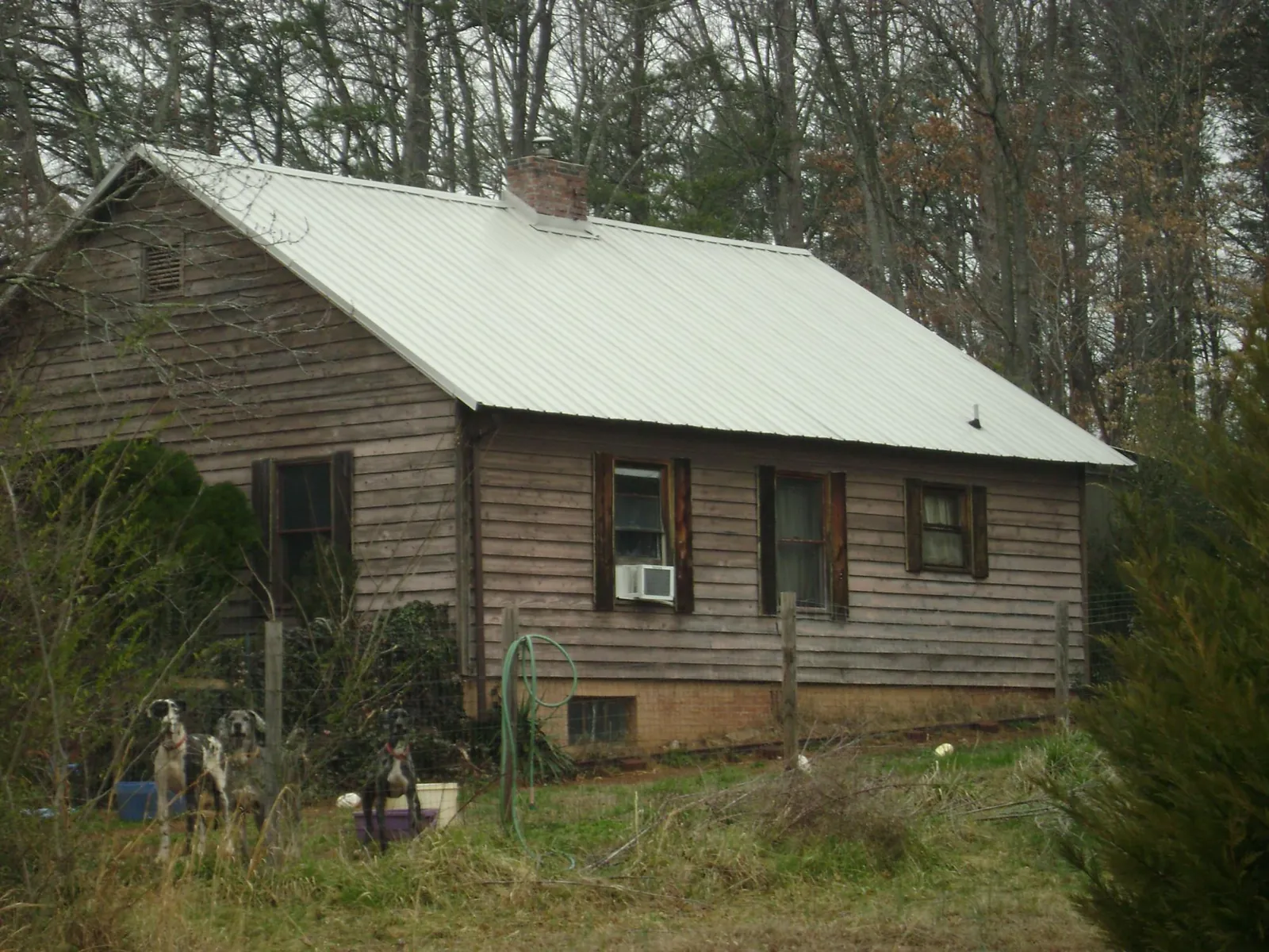 White metal roof on an old wood sided farmhouse, from a Metal Roof Installation job in Veyo